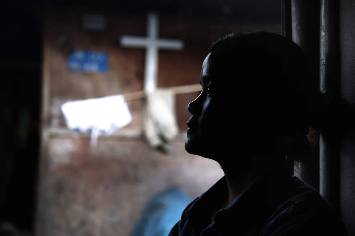 Marip Lu sits in her family's shelter in a refugee camp in Kachin State, Burma, on March 21, 2018. Marip Lu, 24, claims she was kidnapped by traffickers and suffered six years of captivity, rape, and abuse deep in China. (Esther Htusan/AP)