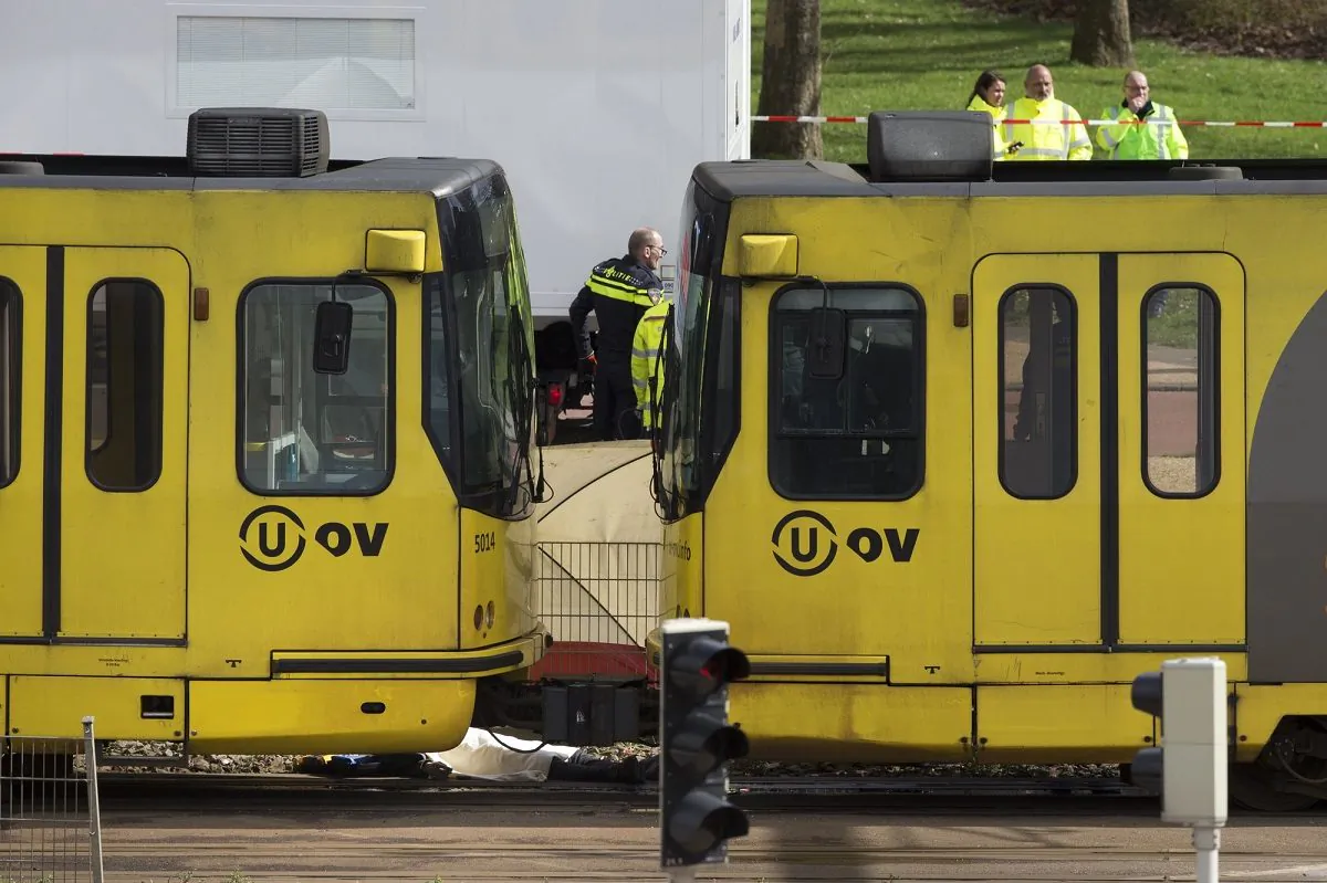 The body of one of three victims is covered with a white sheet as it lies next to a tram after a shooting incident in Utrecht, Netherlands,on Mar. 18, 2019. (Peter Dejong/AP Photo)