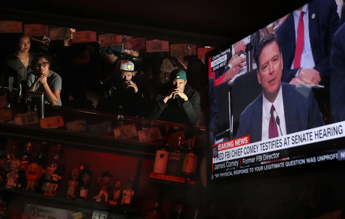 Patrons at Ace's Bar watch a television broadcast of former FBI Director James Comey testify before the Senate Intelligence Committee on June 8, 2017 in San Francisco, United States.  Justin Sullivan/Getty Images