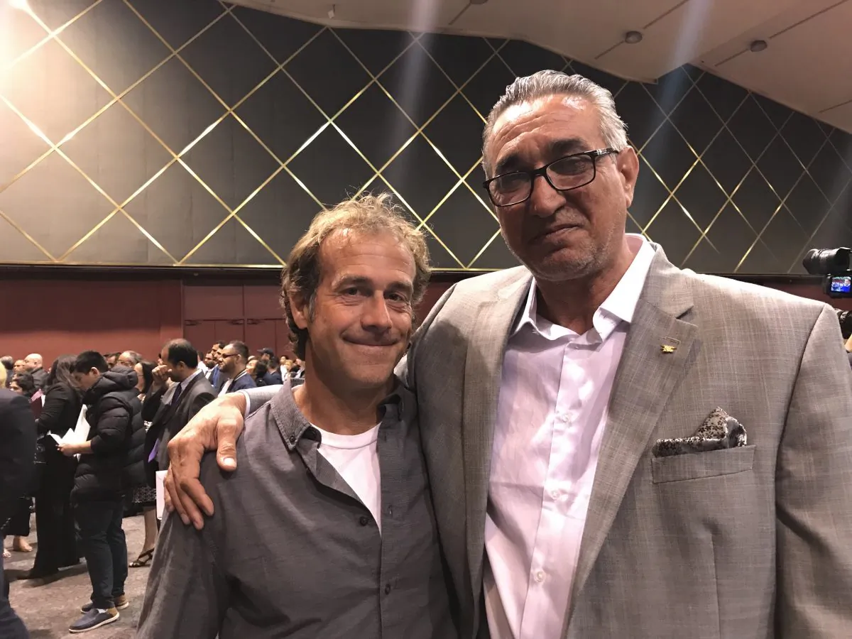Johnny Walker (right), Iraqi interpreter for U.S. military in Iraq, and retired Navy SEAL Jason Tuschen (left) at citizenship ceremony in San Diego, California, on March 20, 2019. (Kimberly Hayek/The Epoch Times)