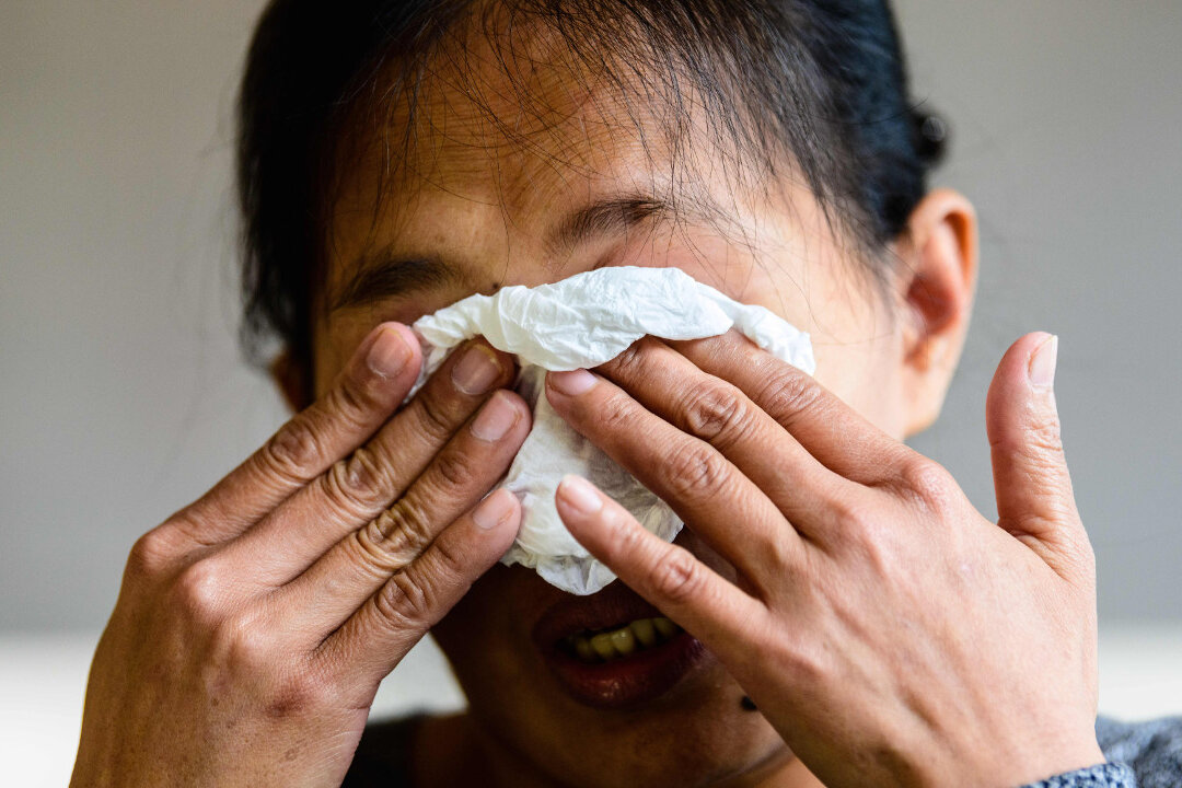 A woman, diagnosed with cancer, cries. (Anthony Wallace/AFP/Getty Images)