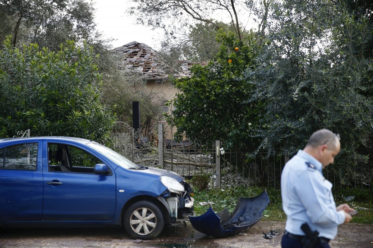 Damage to a house and a car hit by a rocket
