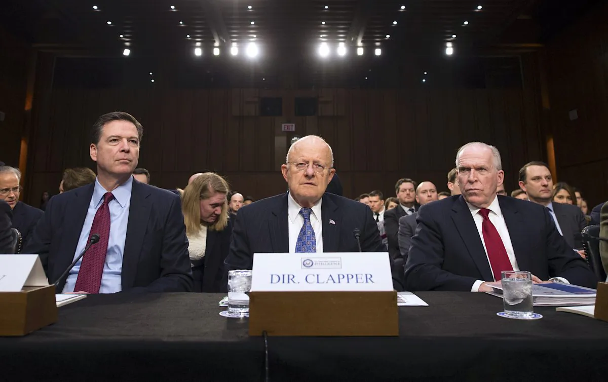 (L-R) Then FBI Director James Comey, Director of National Intelligence James Clapper, and CIA Director John Brennan testify before the Senate Intelligence Committee on Feb. 9, 2016. (MOLLY RILEY/AFP/Getty Images)