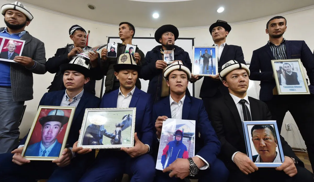 Kyrgyz men hold portraits of relatives they fear are being held in “re-education camps” in China’s Xinjiang region, at a press conference in Bishkek, Kyrgyzstan on Nov. 29, 2018.  (VYACHESLAV OSELEDKO/AFP/Getty Images)