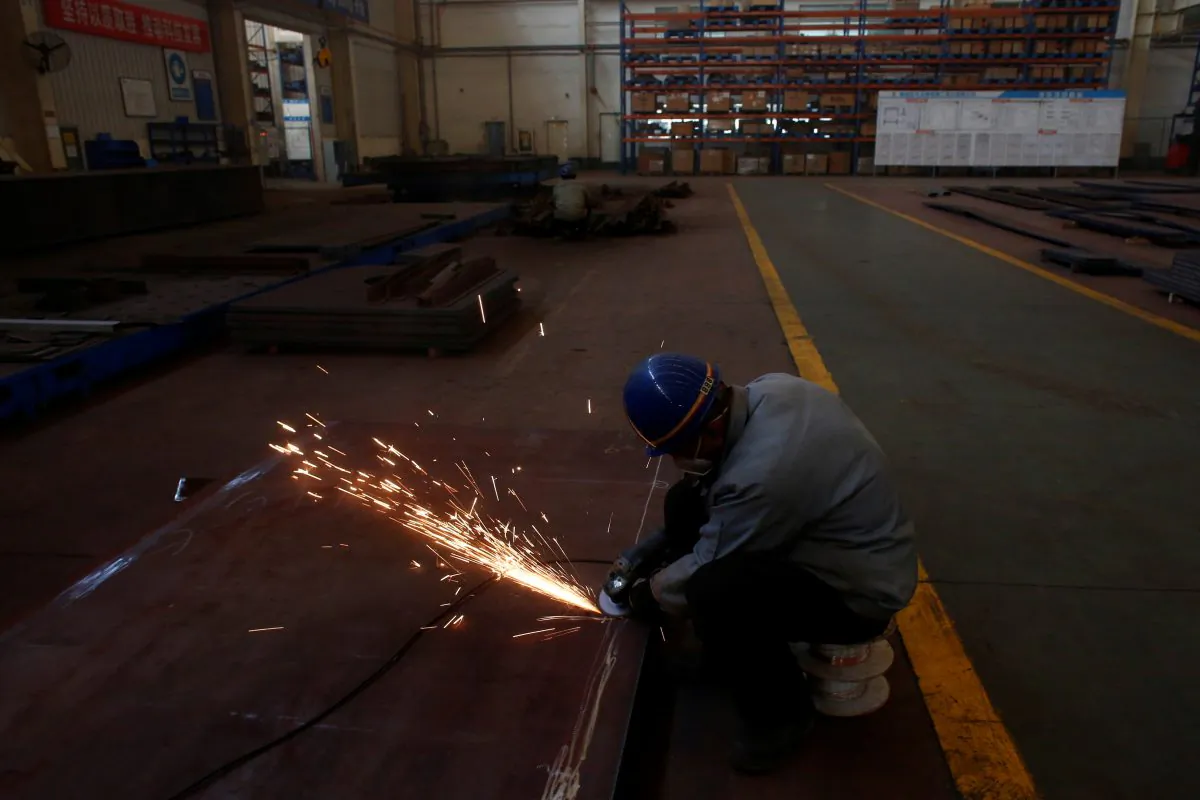 A man works in the Tianye Tolian Heavy Industry Co. factory in Qinhuangdao in the QHD economic development zone, Hebei Province, China on Dec. 2, 2016. (Thomas Peter/Reuters)