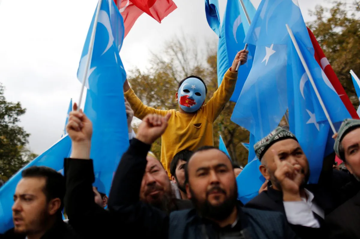 A masked Uyghur boy takes part in a protest against China, at the courtyard of Fatih Mosque, a common meeting place for pro-Islamist demonstrators in Istanbul, Turkey on Nov. 6, 2018. (Murad Sezer/Reuters)