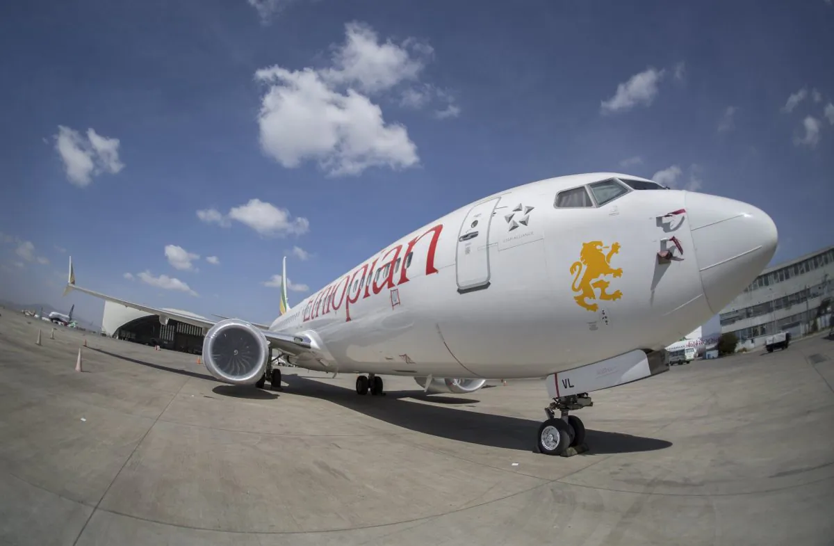 Other Ethiopian Airlines aircraft are seen in the distance behind an Ethiopian Airlines Boeing 737 Max 8 as it sits grounded at Bole International Airport in Addis Ababa, Ethiopia, on March 23, 2019. (Mulugeta Ayene/AP)