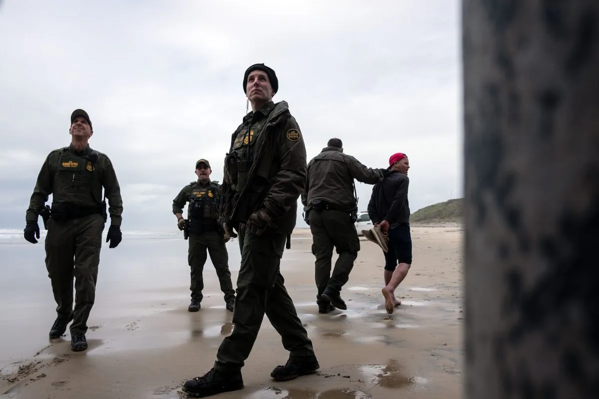 A Central American migrant is taken in custody by Border Patrol after crossing the US-Mexico border fence from Tijuana to San Diego as seen from Playas de Tijuana, in Baja California state, Mexico, on March 21, 2019. (Guillermo Arias/AFP/Getty Images)