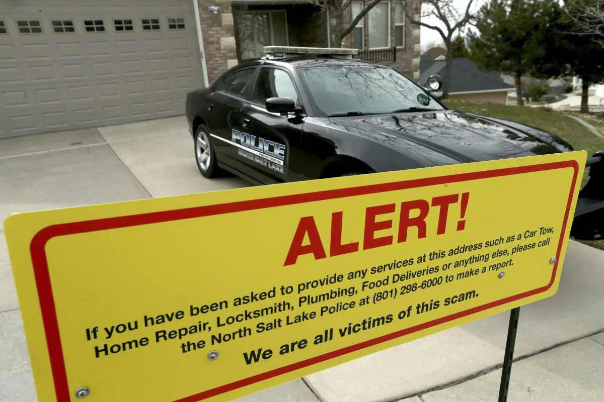 A warning sign and a police officer's vehicle are stationed at Walt Gilmore's home on March 21, 2019. (Laura Seitz/The Deseret News via AP)