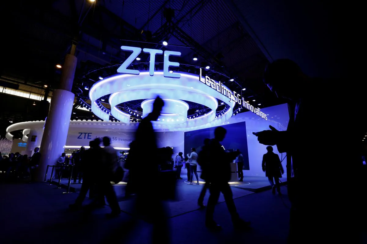 People walk next to ZTE booth at the Mobile World Congress in Barcelona, Spain on Feb. 25, 2019. (Rafael Marchante/Reuters)