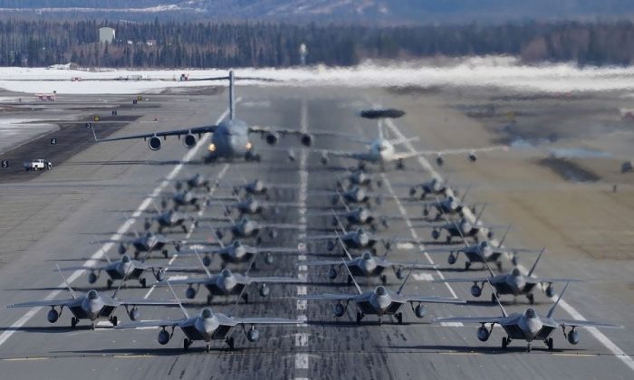 F-22 Raptors participate in an elephant walk with an E-3 Sentry and a C-17 Globemaster III at Joint Base Elmendorf-Richardson, Alaska, on March 26, 2019. (US Air Force)