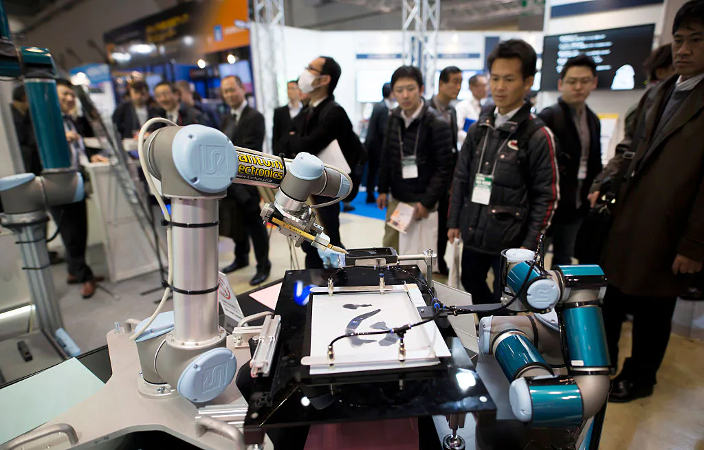Universal Robots A/S robotic arms are demonstrated at the Robodex (Robot Development & Application Expo) trade show in Tokyo, on Jan. 18, 2017 in Tokyo, Japan. (Tomohiro Ohsumi/Getty Images)