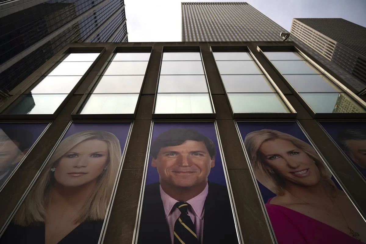 Advertisements featuring Fox News personalities, including Tucker Carlson (C), adorn the front of the News Corporation building in New York on March 13, 2019. (Drew Angerer/Getty Images)