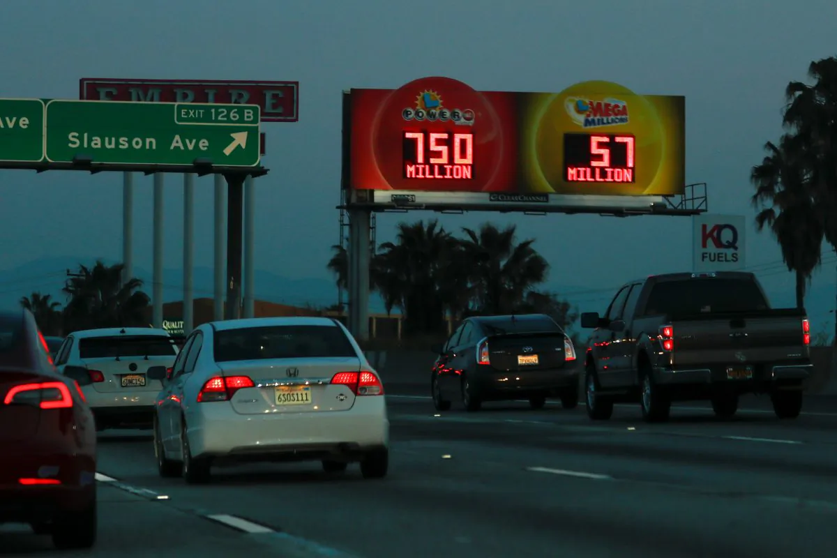 A highway billboard promoting the current Powerball jackpot lottery  reaches out to commuters in Los Angeles, Calif., on March 26, 2019. (Mike Blake/Reuters)