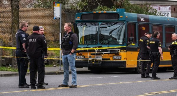 bus with bullet holes and emergency crews