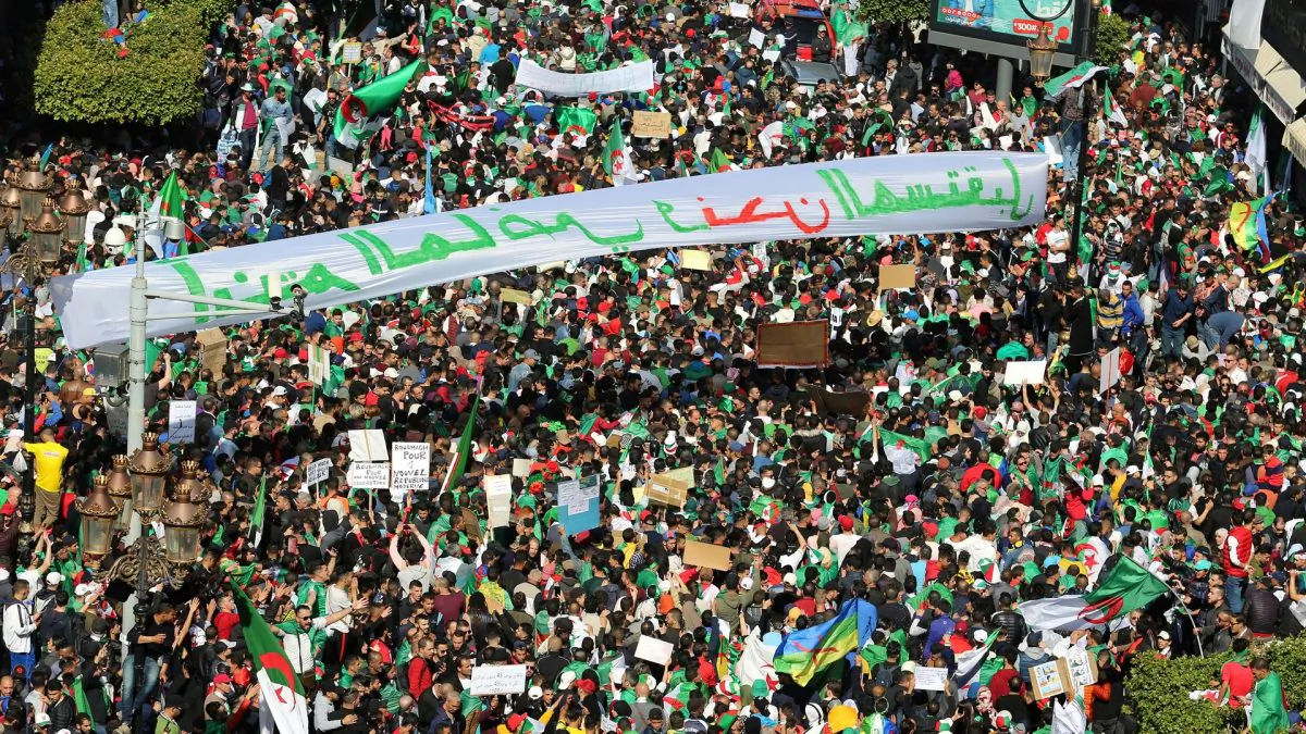People carry national flags and banners during a protest to demand the resignation of President Abdelaziz Bouteflika, in Algiers, Algeria on March 29, 2019. (Ramzi Boudina/Reuters)