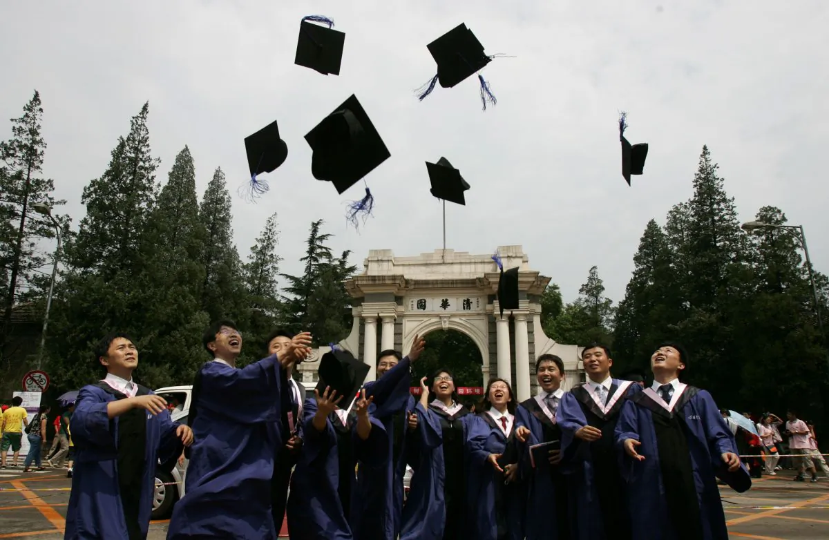 Students throw their mortar boards into the air as they graduate during a ceremony held at the Tsinghua University in Beijing, China on July 18, 2007. (China Photos/Getty Images)
