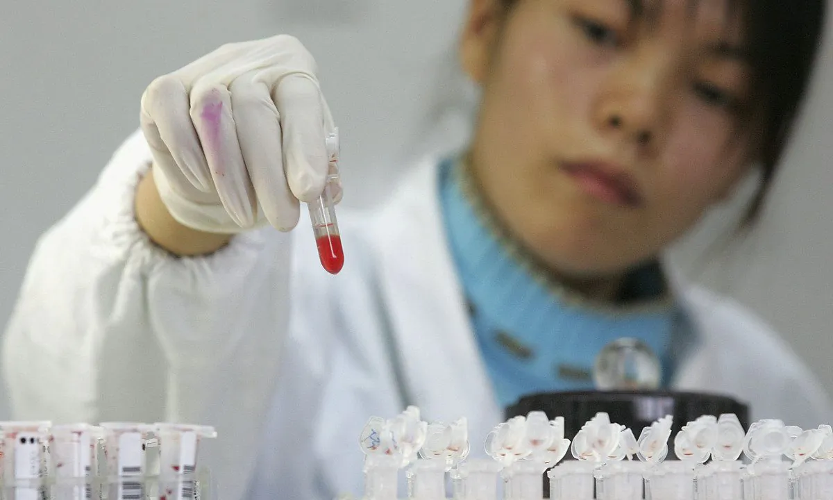 Medical worker with blood vial. (China Photos/Getty Images)
