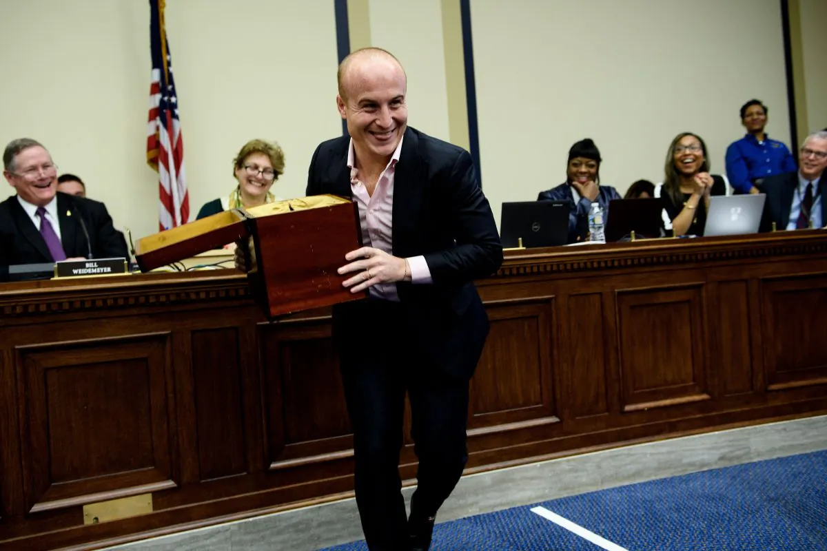 Representative-elect Max Rose (D-N.Y.) jokes about taking the lottery box during an office lottery for new members of Congress on Capitol Hill in Washington on Nov. 30, 2018. (BRENDAN SMIALOWSKI/AFP/Getty Images)