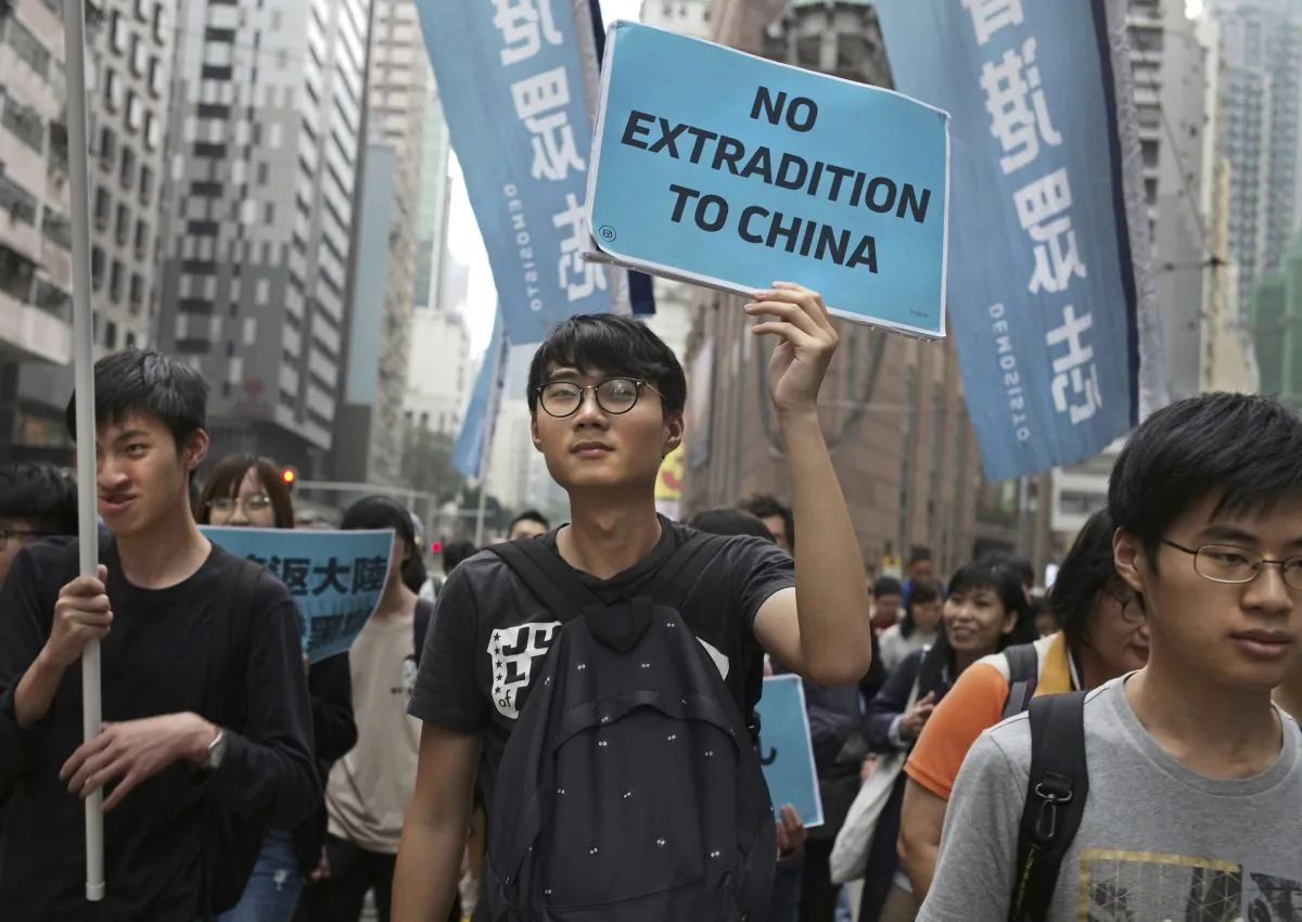 Protesters raise placards and flags during a march against an extradition law as they head toward government headquarters in Hong Kong on March 31, 2019. Thousands of people protest against the proposed changes to the Hong Kong's extradition laws that could see people sent for trial in mainland China, according to government radio. (Vincent Yu/AP Photo)