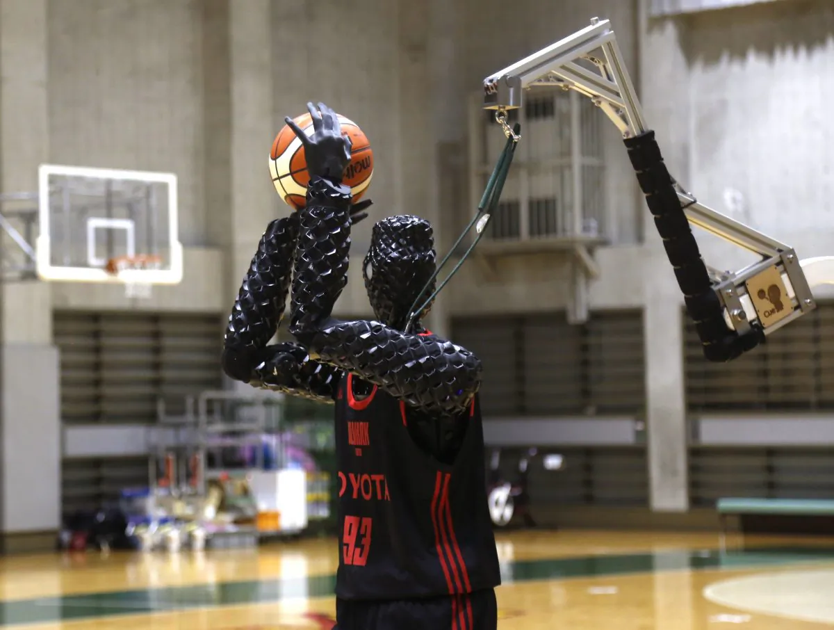 Toyota’s basketball robot Cue 3 demonstrates Monday, April 1, 2019 at a gymnasium in Fuchu, Tokyo. The 207-centimeter (six-foot-10) -tall machine made five of eight three-pointer shots in a demonstration in a Tokyo suburb Monday, a ratio its engineers say is worse than usual. Toyota Motor Corp.’s robot, called Cue 3, computes as a three-dimensional image where the basket is, using sensors on its torso, and adjusts motors inside its arm and knees to give the shot the right angle and propulsion for a swish.(AP Photo/Yuri Kageyama)
