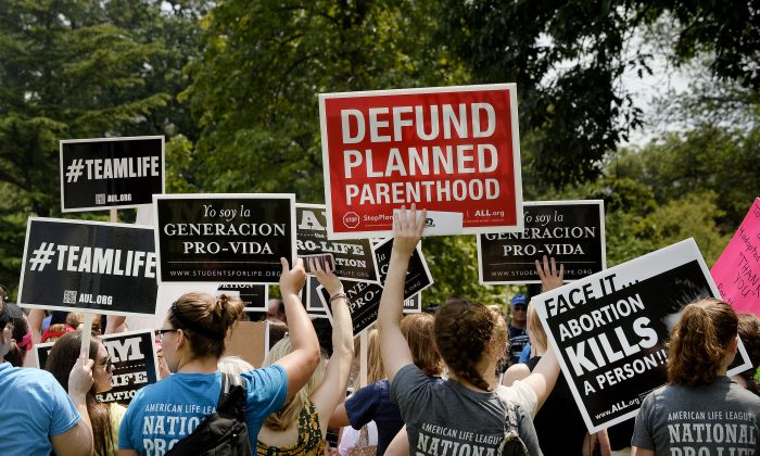 Activists hold a rally opposing federal funding for Planned Parenthood in front of the Capitol in Washington on July 28, 2015. (Olivier Douliery/Getty Images)
