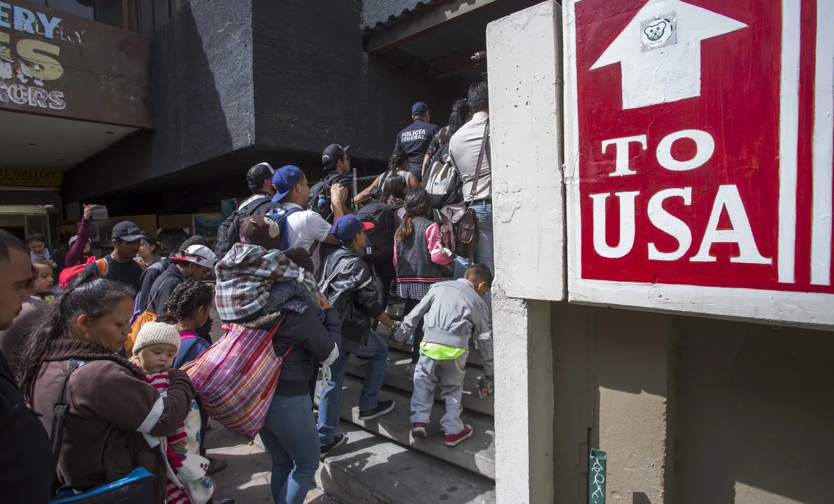 Members of a caravan of Central Americans who spent weeks traveling across Mexico walk from Mexico to the U.S. side of the border to ask authorities for asylum in Tijuana, Baja California Norte, Mexico, on April 29, 2018.  (David McNew/Getty Images)