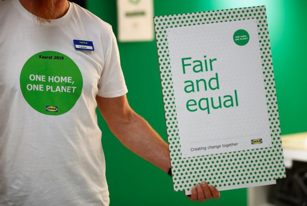 An employee of IKEA, holds a "fair and equal"