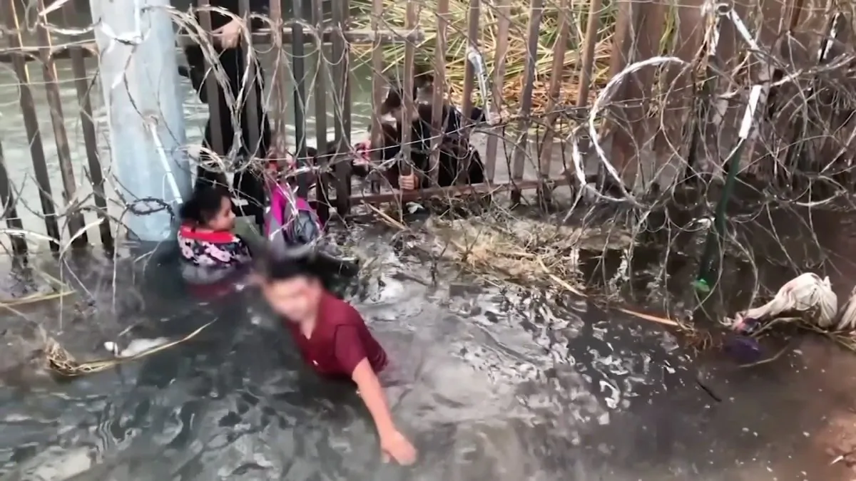 Several small children cry as smugglers try to help adults and children get through a hole in a border fence, in Yuma, Arizona, on Dec. 22, 2018. (U.S. Customs and Border Protection)