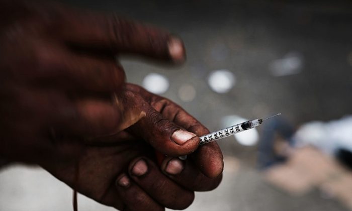 A heroin user displays a needle in a South Bronx neighborhood which has the highest rate of heroin-involved overdose deaths in New York City, on Oct. 6, 2017. (Spencer Platt/Getty Images)