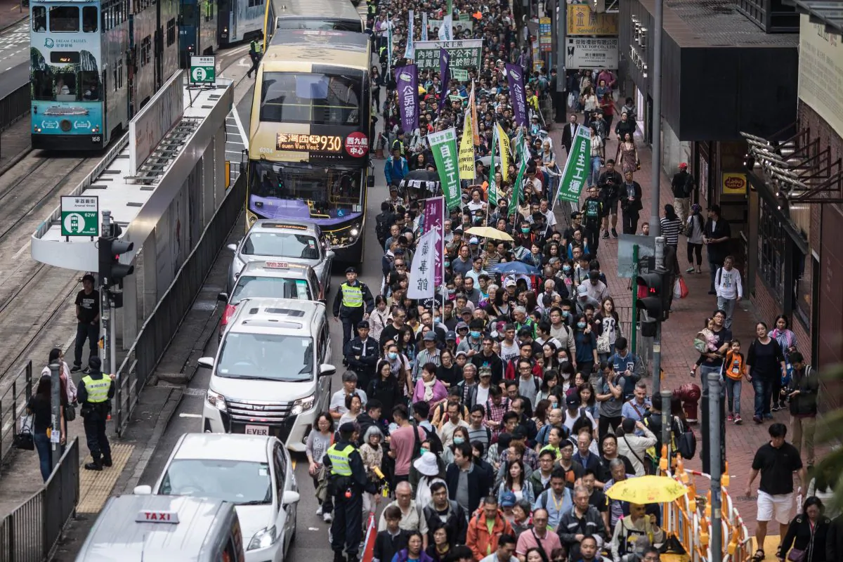 Protesters march along a street during a rally in Hong Kong on March 31, 2019 to protest against the government's plans to approve extraditions with mainland China, Taiwan and Macau. - Critics fear any extradition agreement could leave both business figures and dissidents in Hong Kong vulnerable to China's politicised courts, fatally undermining a business hub that has thrived off its reputation for a transparent and independent judiciary. (Photo by Dale DE LA REY / AFP) (Photo credit should read DALE DE LA REY/AFP/Getty Images)