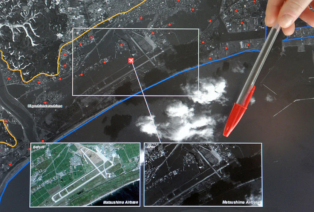 A technician shows with a pen a satellite image of Japan at the Regional Service of Image Treatment and Remote Sensing (SERTIT) in Illkirch Graffenstaden, eastern France, on March 15, 2011. (Frederick Florin/AFP/Getty Images)