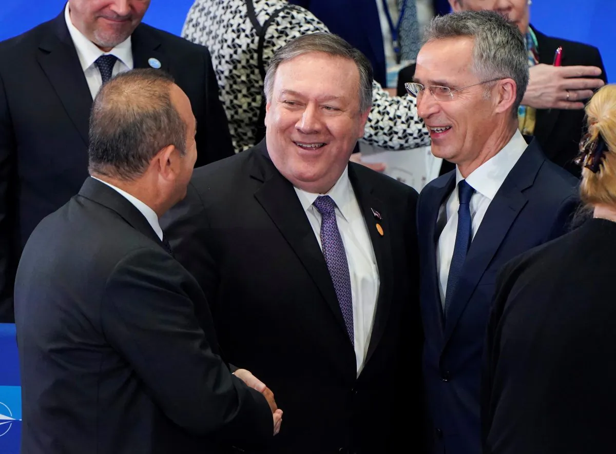 Turkish Foreign Minister Mevlut Cavusoglu greets U.S. Secretary of State Mike Pompeo and NATO Secretary General Jens Stoltenberg at a meeting of the North Atlantic Treaty Organization (NATO) Foreign Ministers at the State Department in Washington, U.S., April 4, 2019.      REUTERS/Joshua Roberts