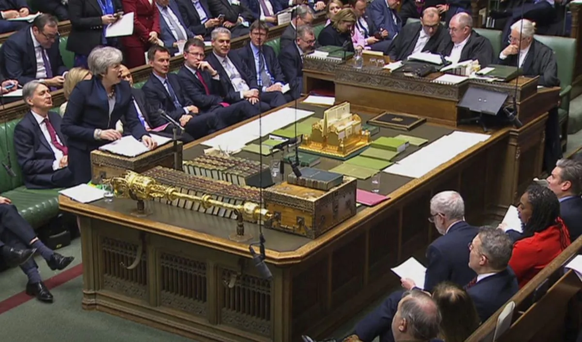 In this grab taken from video, Britain's Prime Minister Theresa May speaks during Prime Minister's Questions in the House of Commons, London, Wednesday April 3, 2019. With Britain racing toward a chaotic exit from the European Union within days, May veered away from the cliff-edge Tuesday, saying she would seek another Brexit delay and hold talks with the opposition to seek a compromise. (House of Commons/PA via AP)