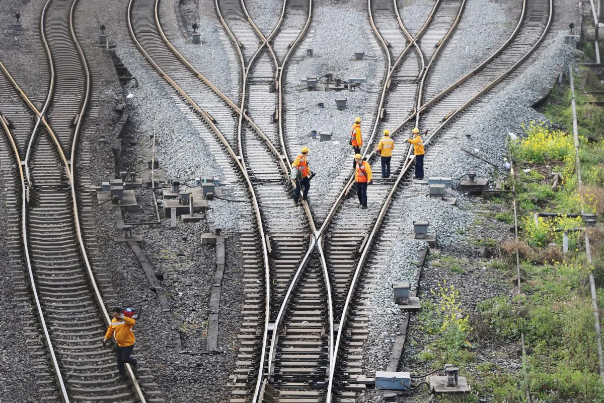 Workers inspect railway tracks, which serve as a part of the "One Belt, One Road" freight rail route linking Chongqing to Duisburg, at the Dazhou railway station in Sichuan Province, China on March 14, 2019. (Reuters)