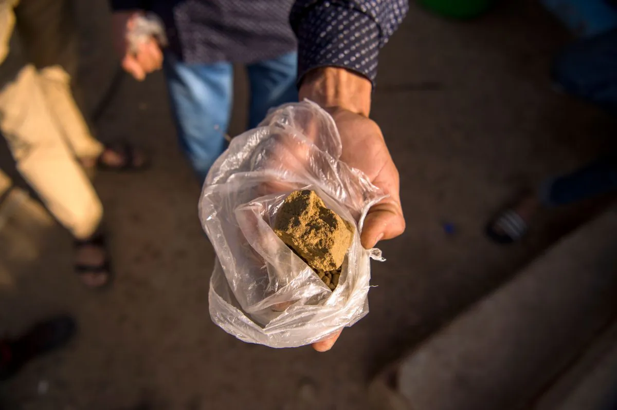 A farmer displays a piece of cannabis resin (hashish) near the town of Ketama in Morocco's northern Rif region on Sept. 13, 2017. (Fadel Senna/AFP)