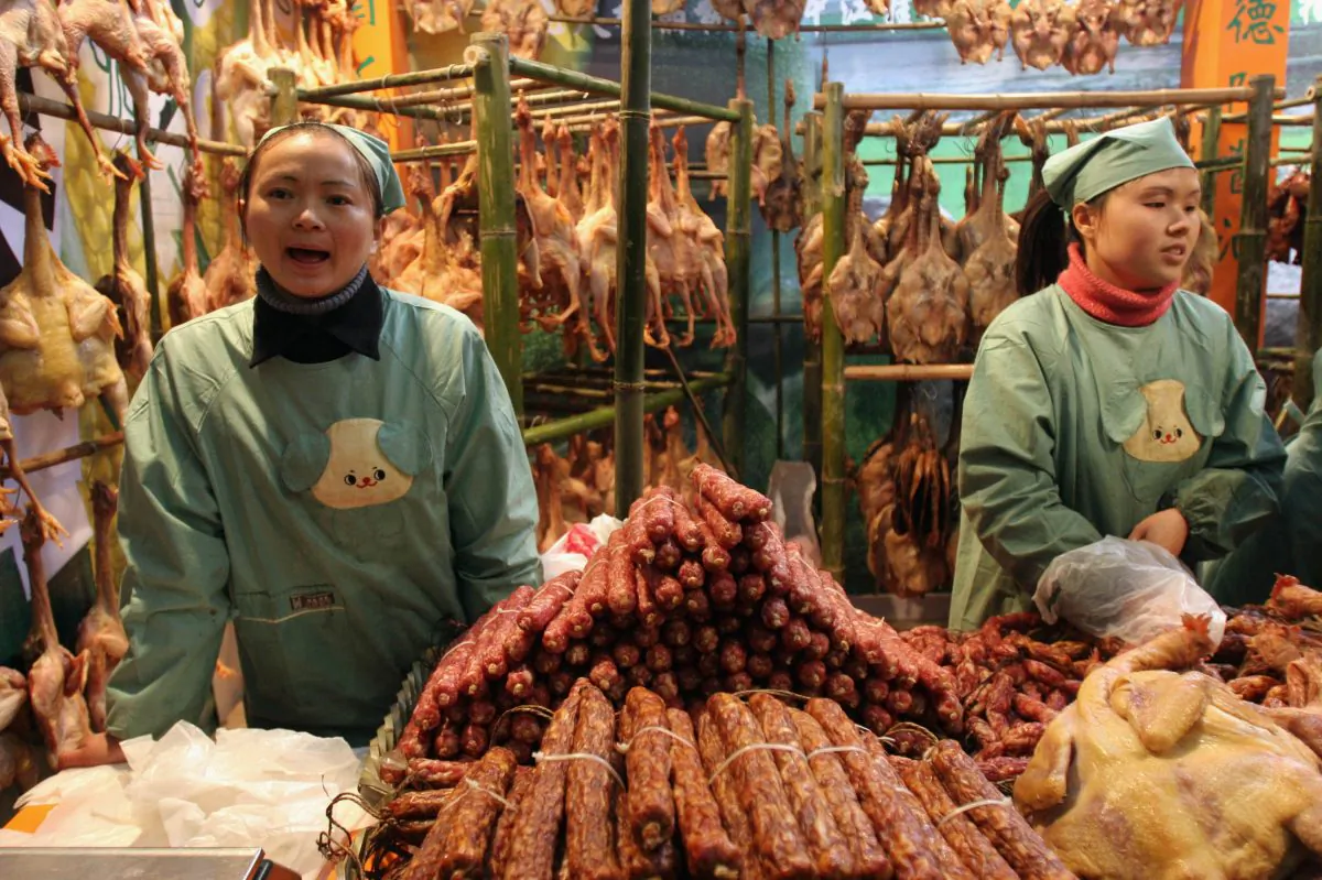 Vendors sell preserved food at a market January 23, 2005 in Chengdu of Sichuan Province, China. China made pork products were detected African swine fever virus in several countries. (China Photos/Getty Images)