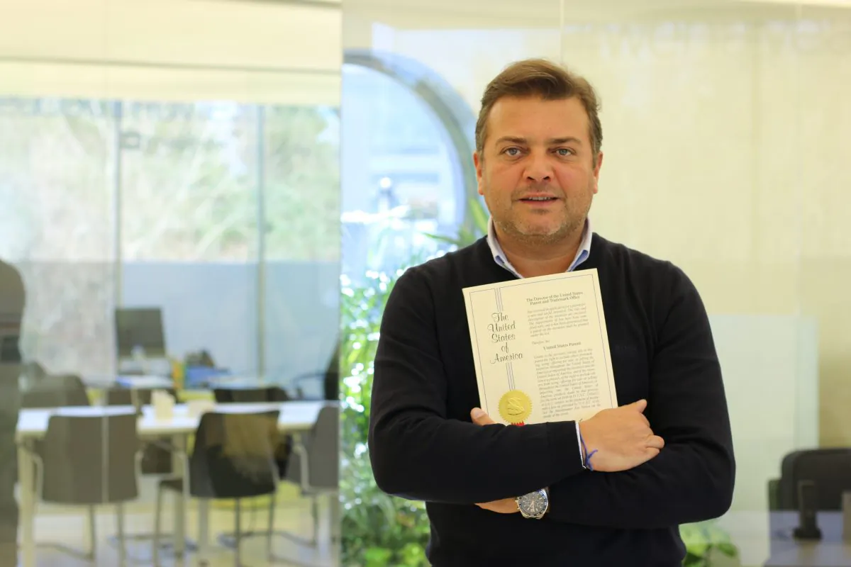 Portuguese entrepreneur Rui Pedro Oliveira holding the patent certificate for his smartphone attachable camera. (Supplied)