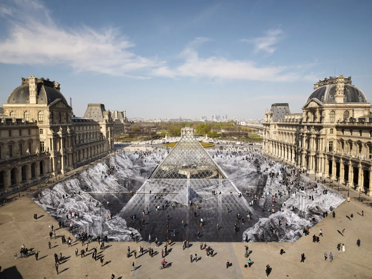 French Street Artist JR used 2,000 pieces of paper to create the Secret of the Great Pyramid, an optical illusion of the Louvre pyramid emerging from a rock quarry, on March 30, 2019. (Courtesy of JR/Twitter)