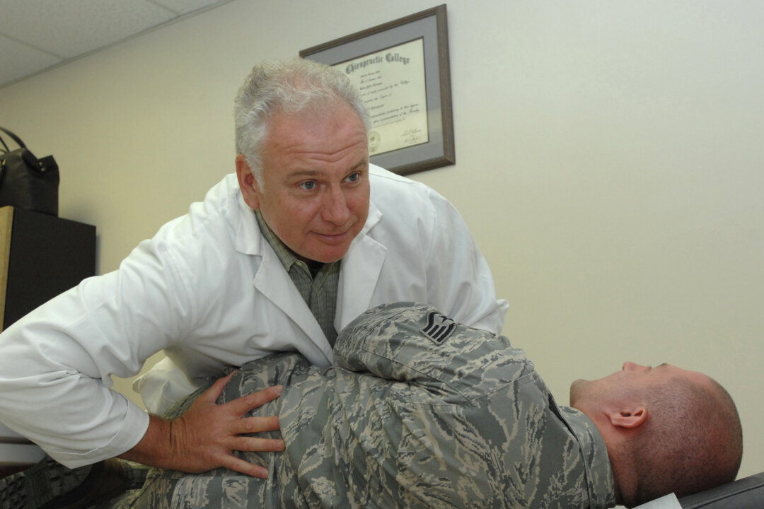 Dr. Brian Brennan performs a lower back alignment for Staff Sgt. Robert Barnett Aug. 9, 2011, in the Wilford Hall Medical Center Chiropractic Clinic, Lackland Air Force Base, Texas. Back alignments can help relieve lower back pain. (U.S. Air Force photo by Audrey Acuna)