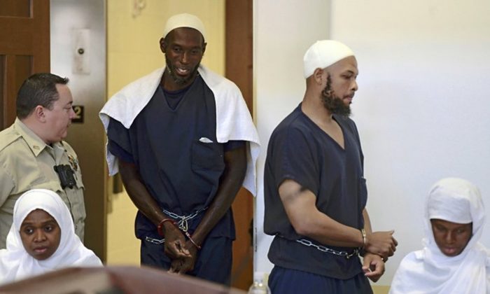 This Aug. 13, 2018 pool file photo shows defendants, from left, Jany Leveille, Lucas Morton, Siraj Ibn Wahhaj and Subbannah Wahhaj entering district court in Taos, N.M. U.S. prosecutors will not seek the death penalty against the four adults who lived at a New Mexico compound where authorities found the remains of a toddler who was reported missing in Georgia, court documents say. (Roberto E. Rosales/The Albuquerque Journal via AP, Pool, File)
