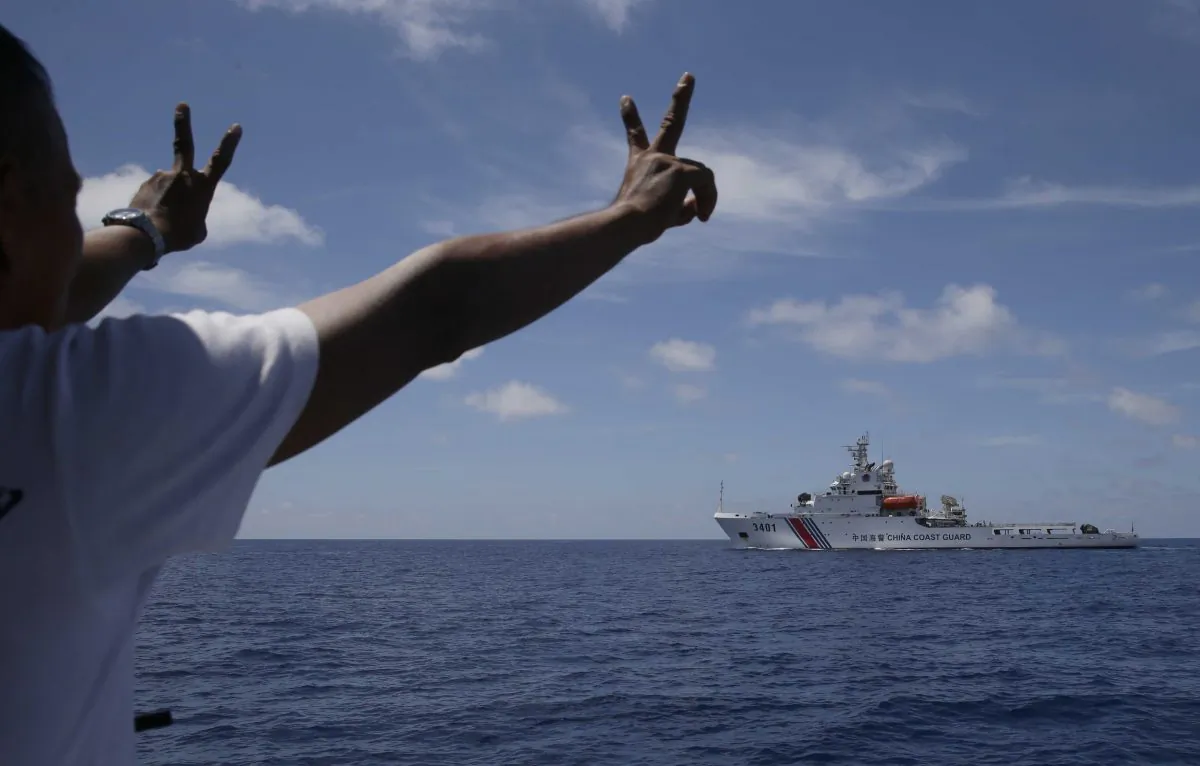 A China Coast Guard vessel attempts to block a Philippine government vessel as the latter tries to enter the China Second Thomas Disputed Shoals, locally known as Ayungin Shoal, to orate Philippine troops and resupply provisions on March 29, 2014. (Bullit Marquez/AP)