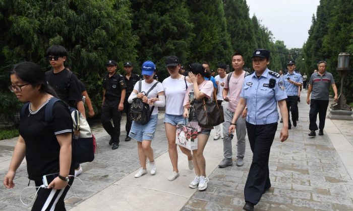 Hundreds of police swarmed the streets of Beijing's financial district on August 6 as Chinese authorities aggressively quashed a planned protest against losses sustained by peer-to-peer (P2P) lending platforms. (Greg Baker/AFP/Getty Images)