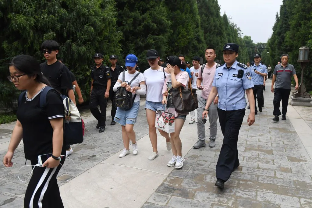 Hundreds of police swarmed the streets of Beijing's financial district on August 6 as Chinese authorities aggressively quashed a planned protest against losses sustained by peer-to-peer (P2P) lending platforms. (Greg Baker/AFP/Getty Images)