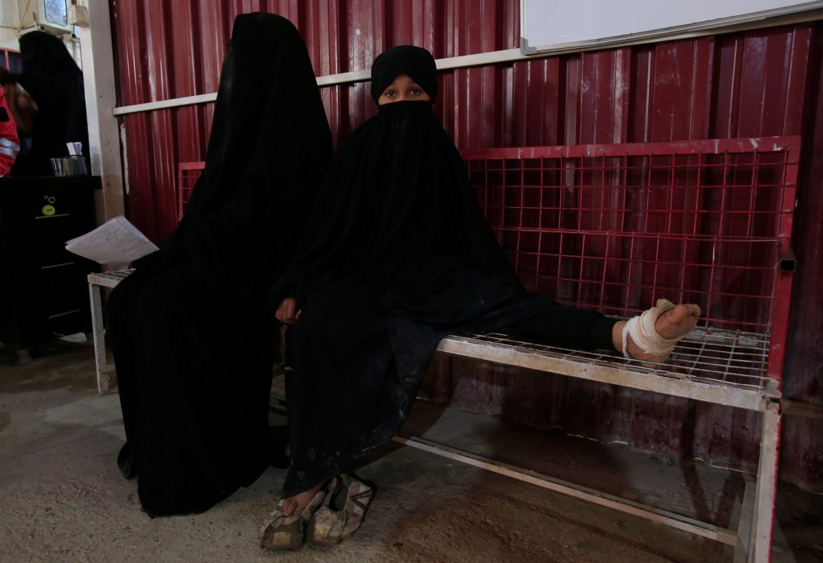 A wounded girl sits at a clinic at al-Hol displacement camp in Hasaka governorate