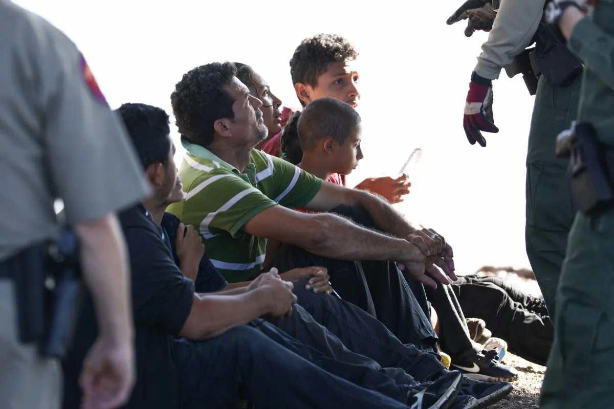 Illegal border crossers are apprehended by Border Patrol after crossing the Rio Grande from Mexico into Eagle Pass, Texas, on Feb. 16, 2019. (Charlotte Cuthbertson/The Epoch Times)