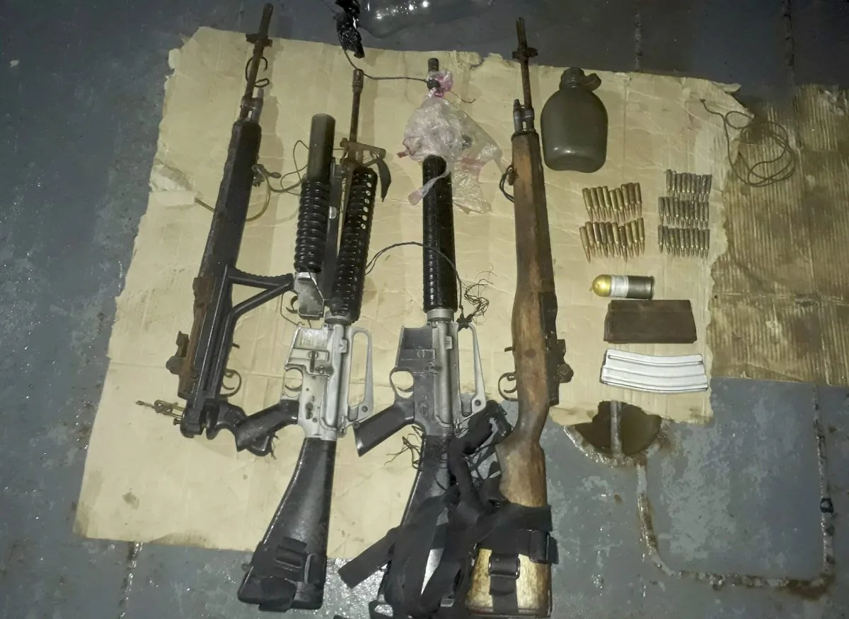 Recovered firearms from kidnappers, aligned with the Muslim terrorist group Abu Sayyaf, following a rescue operation that freed Indonesian hostage Heri Ardiansyah and two others off Simisa island, Sulu Province in the southern Philippines, on April 7, 2019. (WestMinCom Armed Forces of the Philippines via AP)