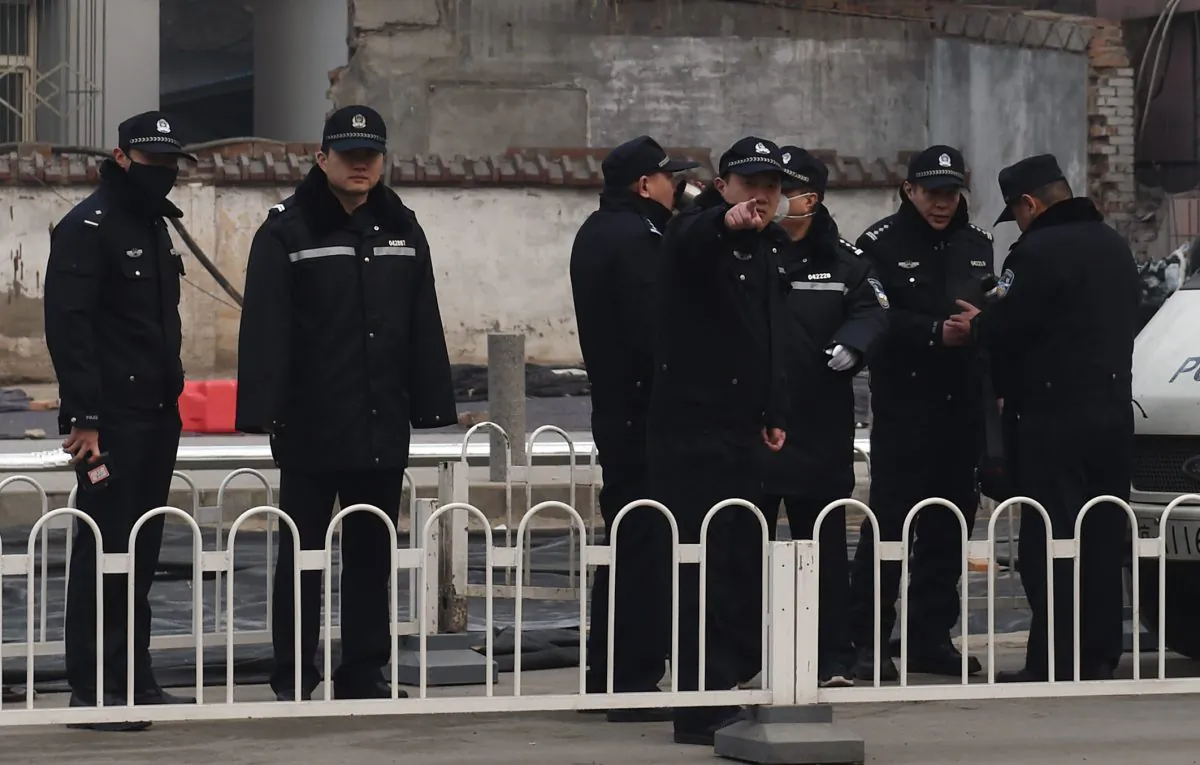 Police stand guard outside the No. 2 Intermediate People's Court where human rights lawyer Pu Zhiqiang was being sentenced in Beijing on December 22, 2015. (GREG BAKER/AFP/Getty Images)