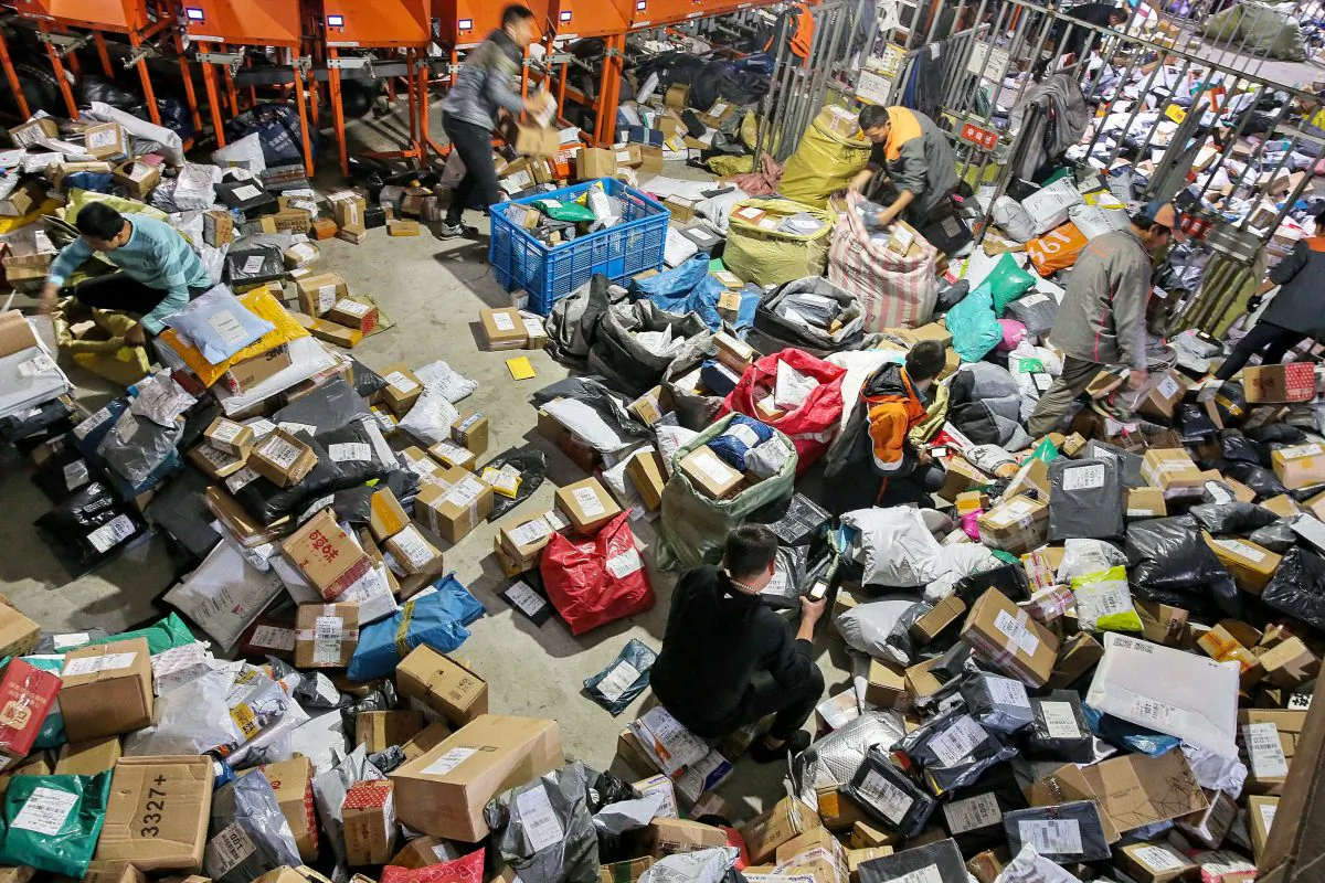 Workers sort packages after the "Singles Day" online shopping festival at a delivery company in Nantong City, Jiangsu Province, China, on November 15, 2018. (STR/AFP/Getty Images)