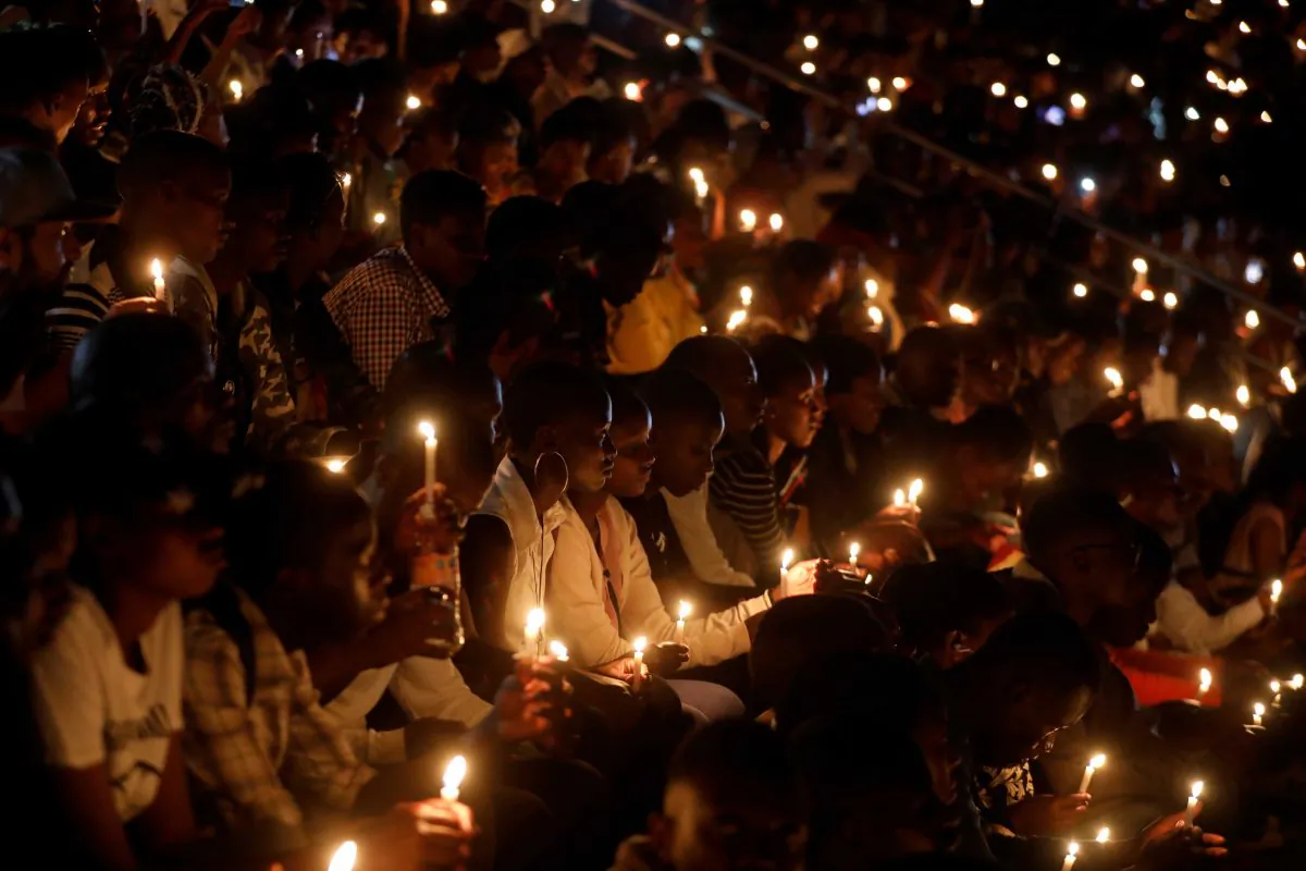 Participants hold candles while holding a night vigil during a commemoration ceremony marking the 25th anniversary of the Rwandan genocide, at the Amahoro stadium in Kigali, Rwanda April 7, 2019. REUTERS/Baz Ratner